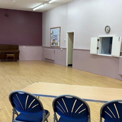 Photo of the Main Hall showing kitchen hatch and piano